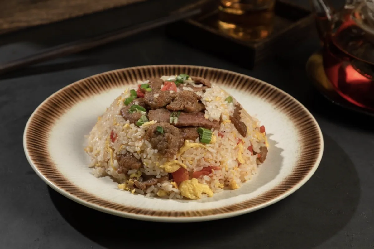 Fried rice with beef and egg on a ceramic plate